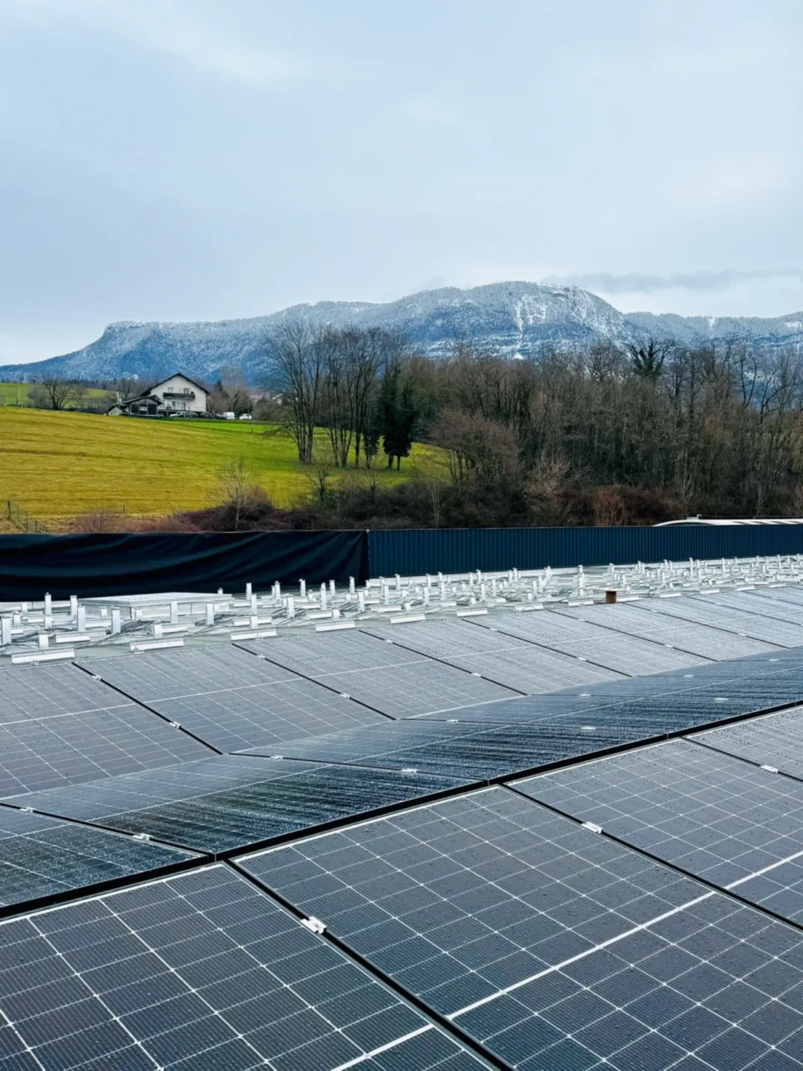 Installation solaire photovoltaïque, Mont Revard en arrière-plan un jour de pluie